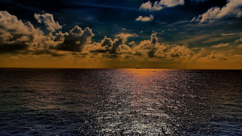 Ocean at sunset with dramatic clouds
