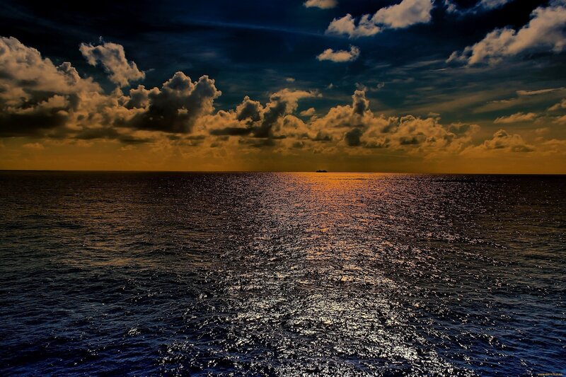 Ocean at sunset with ship