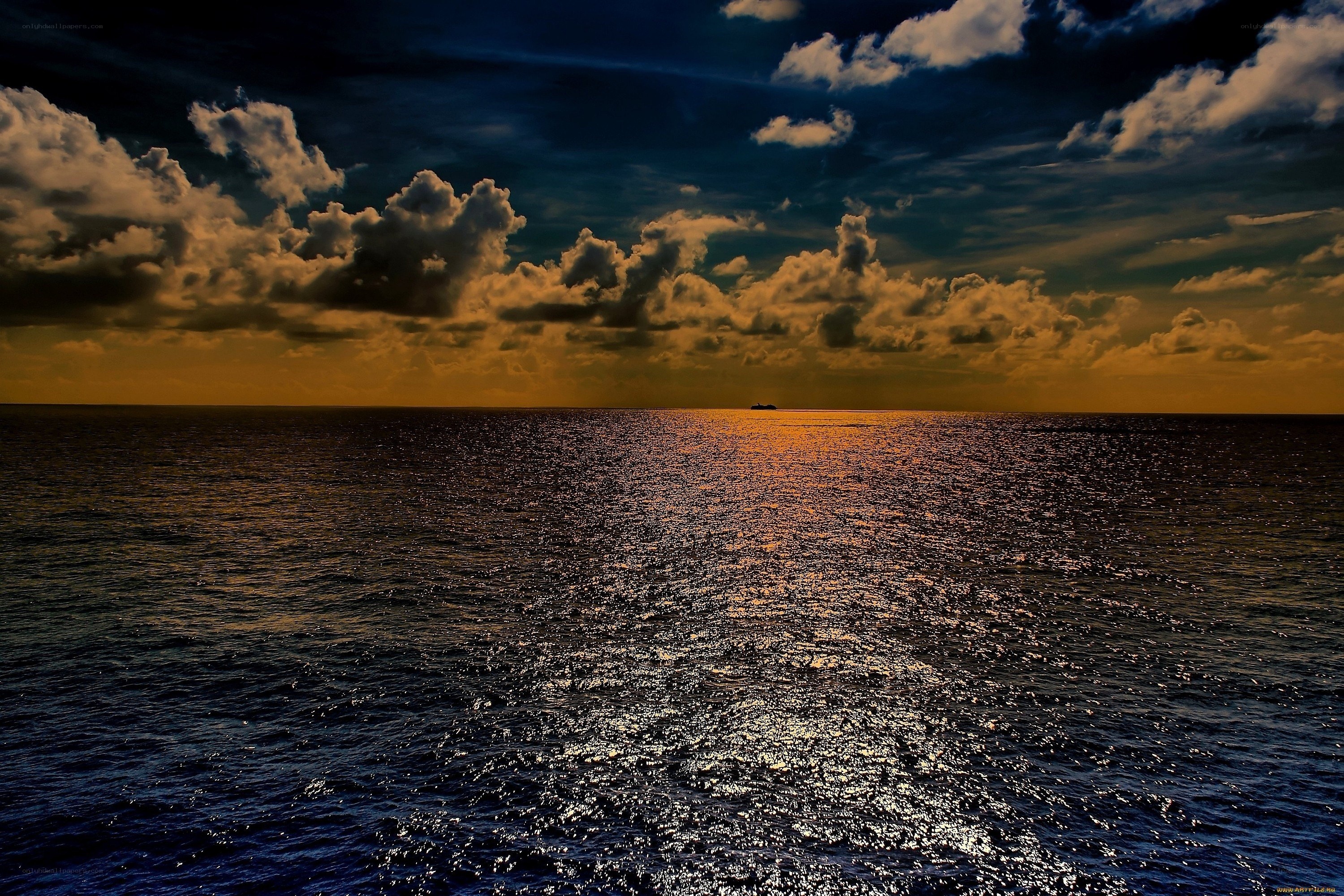 Ocean at sunset with ship