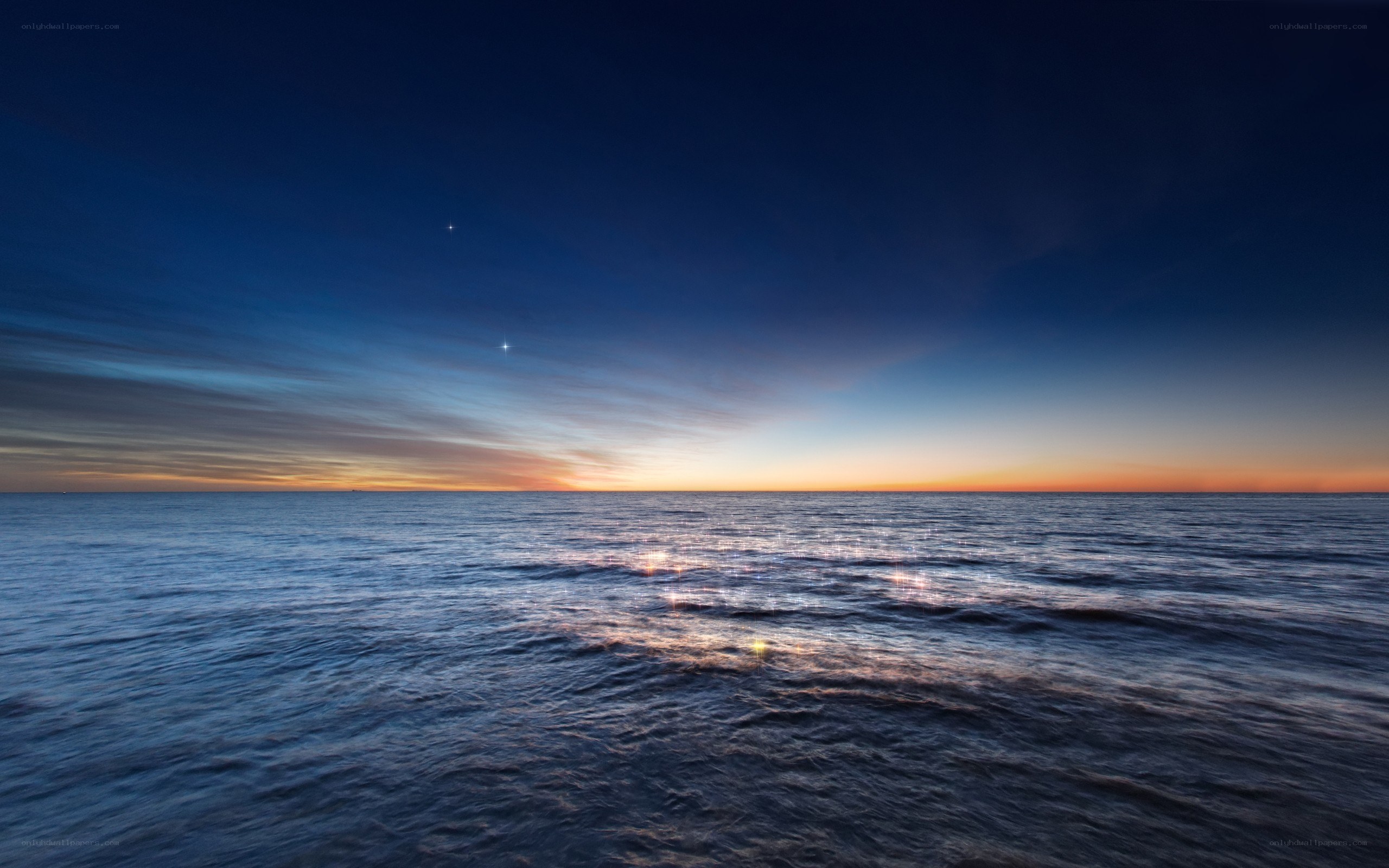 Ocean at twilight with stars