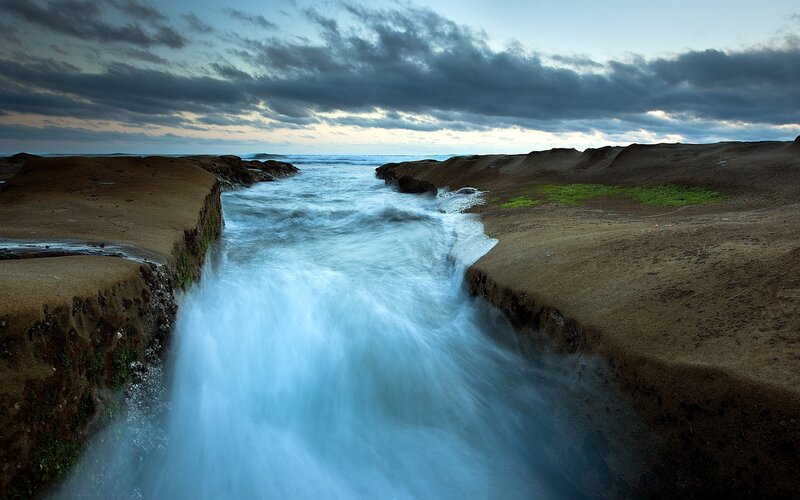 Ocean stream between rocky cliffs