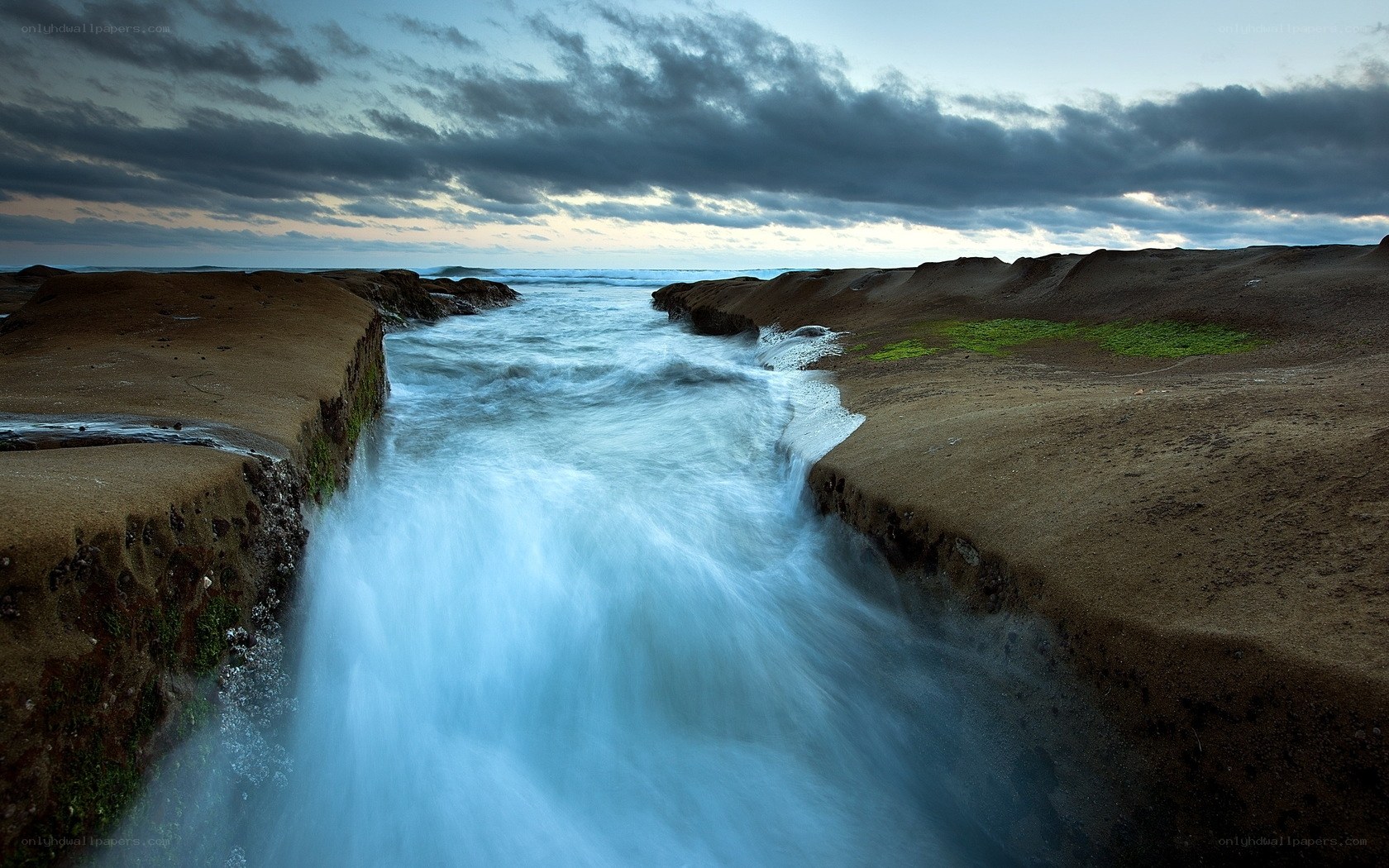 Ocean stream between rocky cliffs