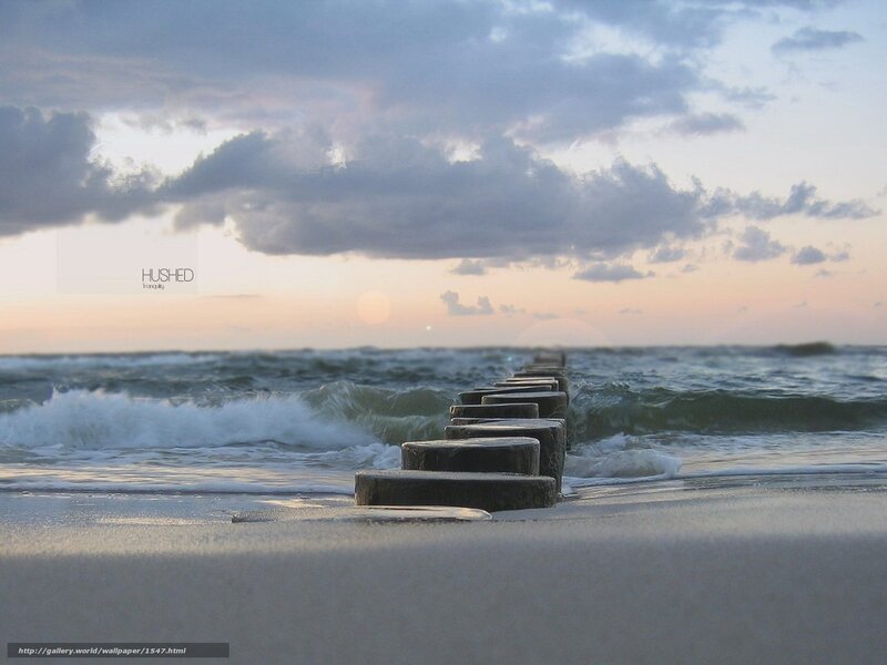 Ocean sunset with wooden breakwater