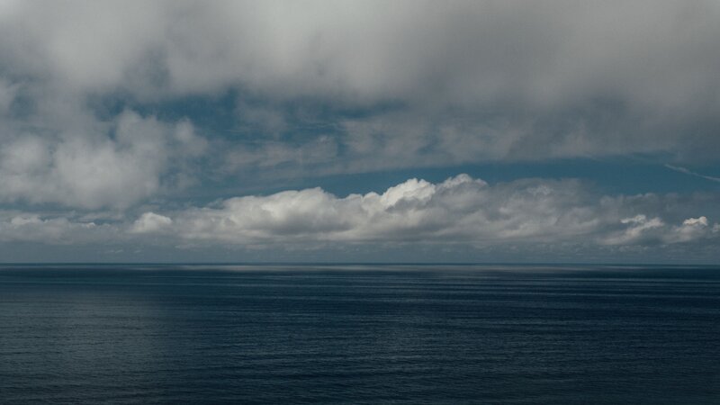 Ocean under cloudy sky