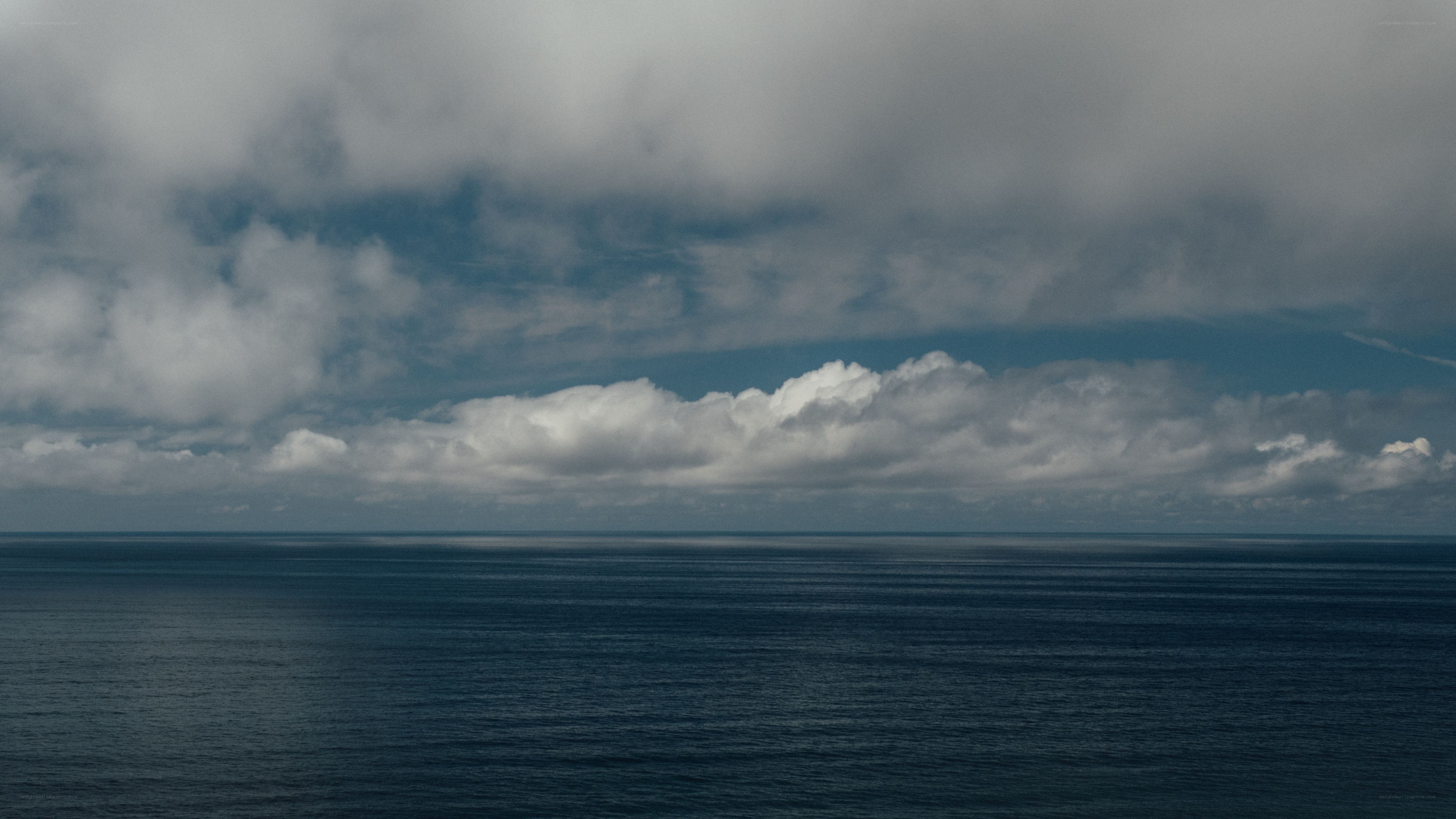 Ocean under cloudy sky