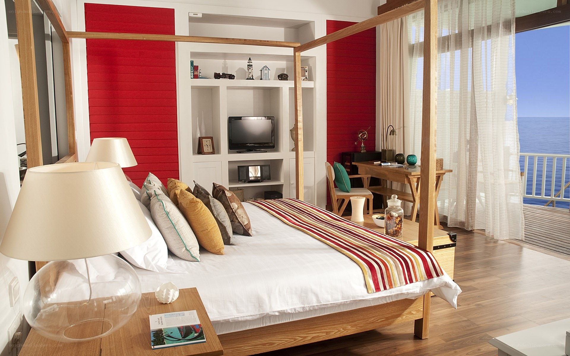 Ocean-view bedroom with red accent wall