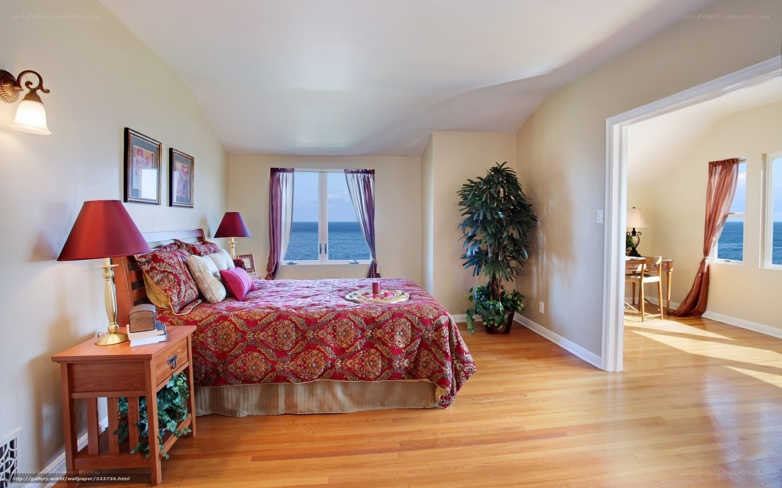 Ocean view bedroom with red bedding