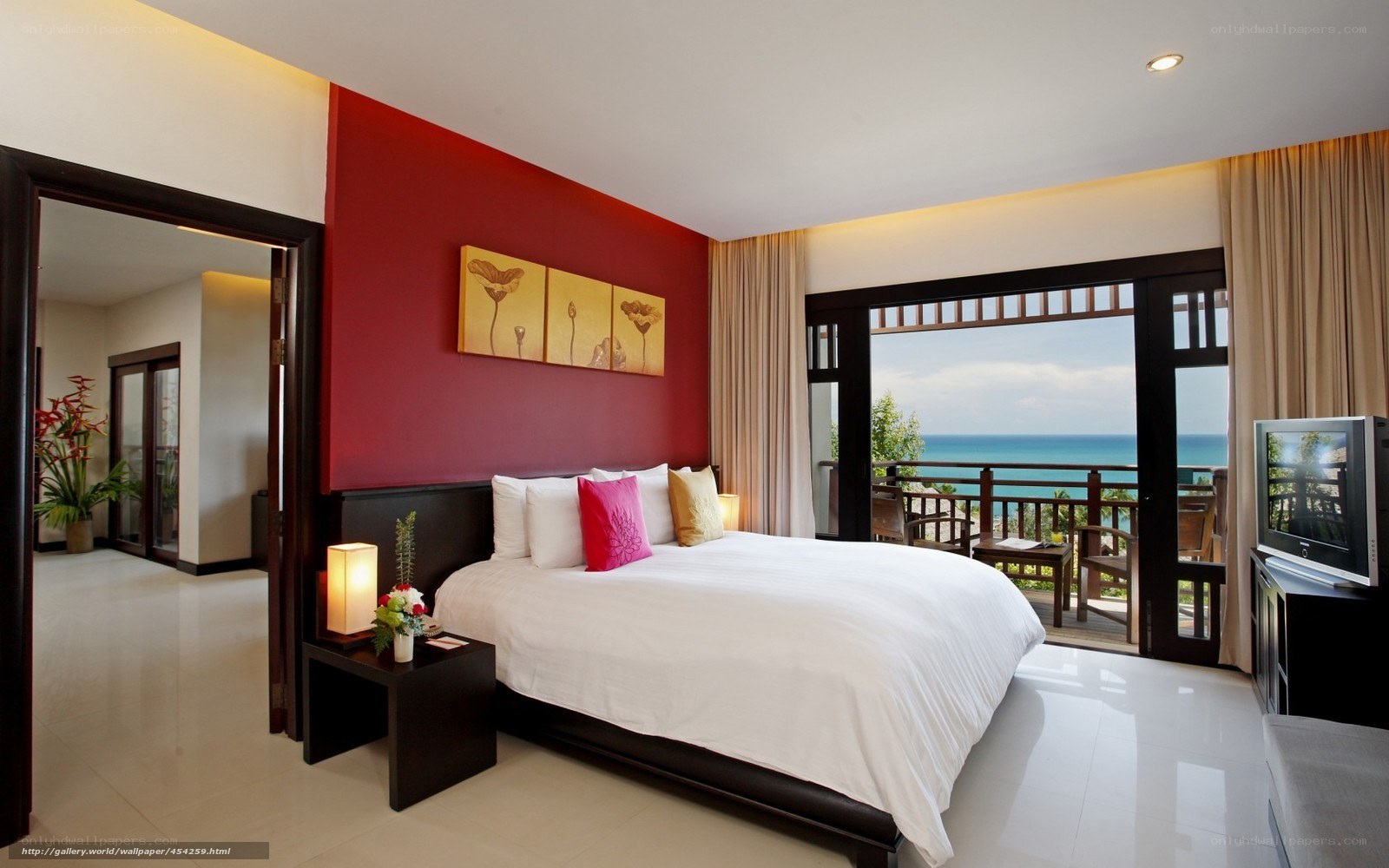 Ocean-view hotel room with red accent wall