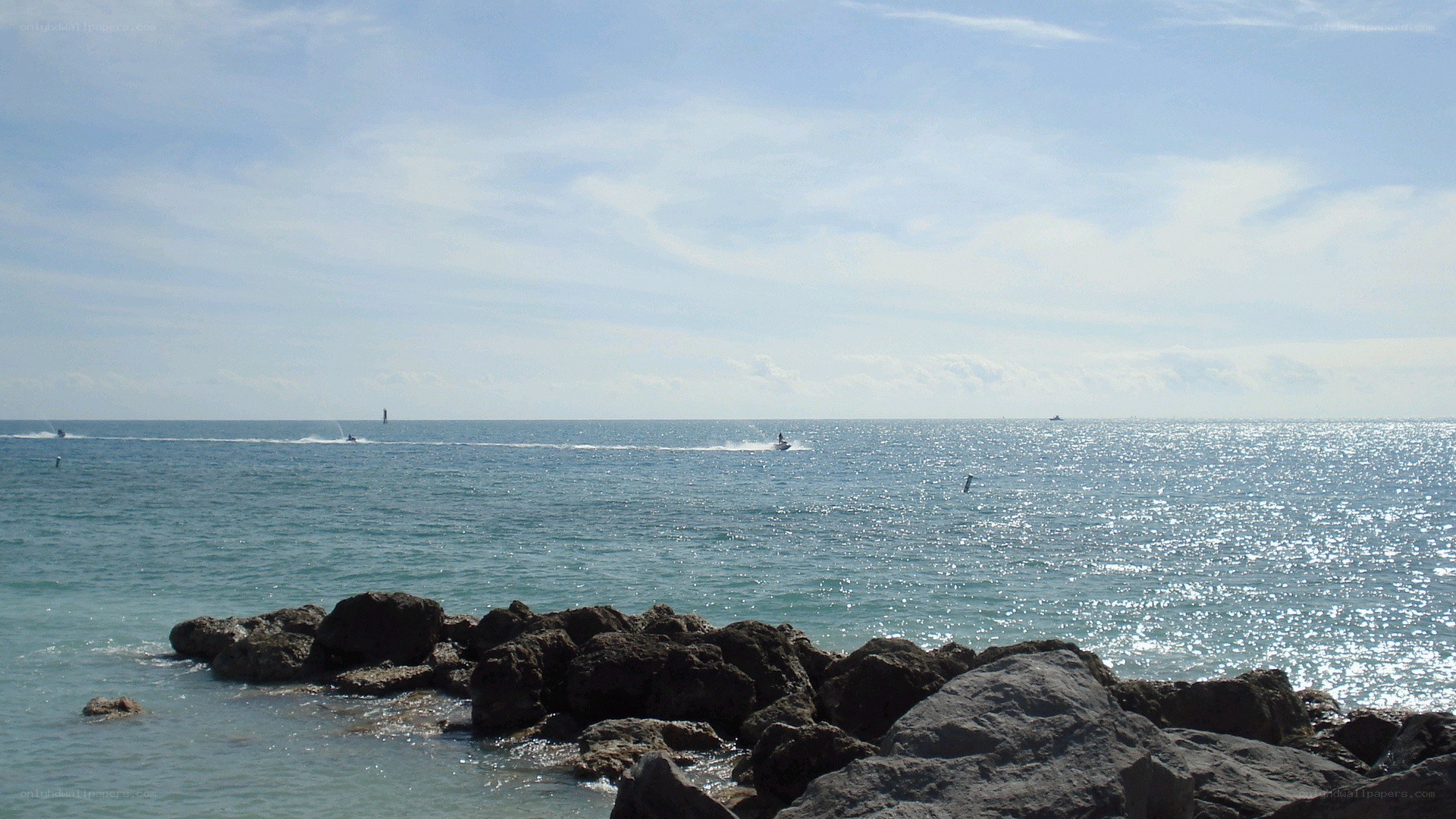 Ocean view with boats and rocks