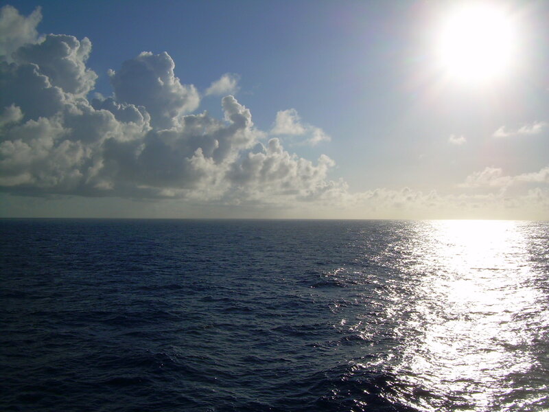 Ocean view with sun and clouds