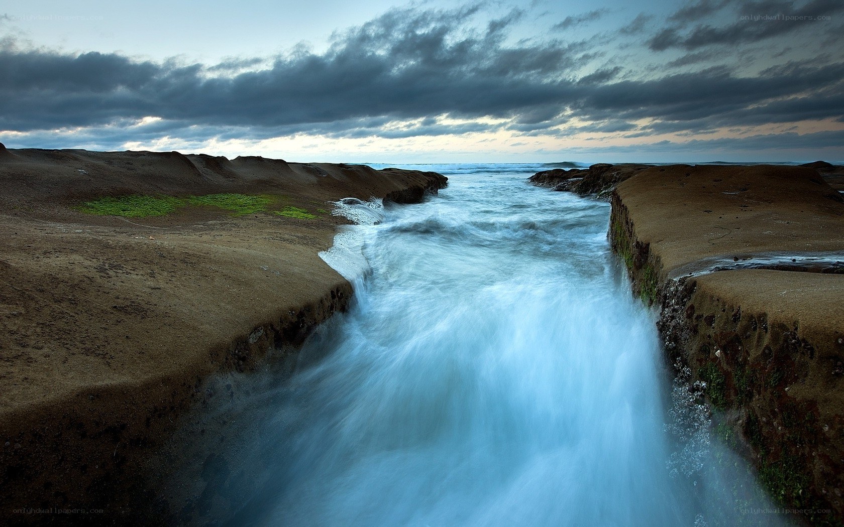 Ocean water flowing through rock channel