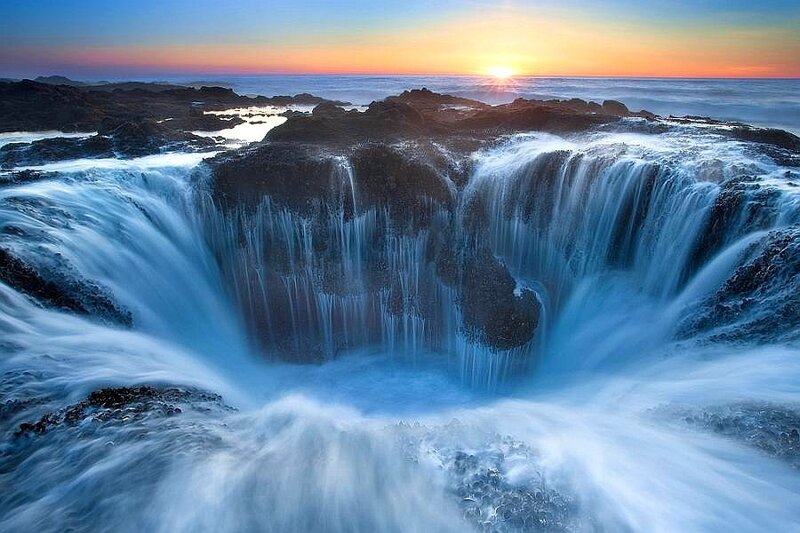 Ocean waterfall at sunset