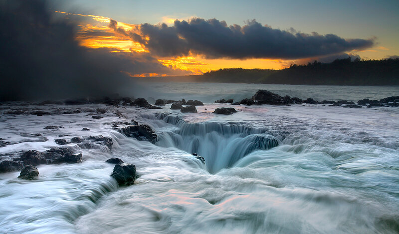 Ocean waterfall at sunset