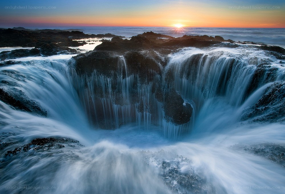 Ocean waterfall at sunset