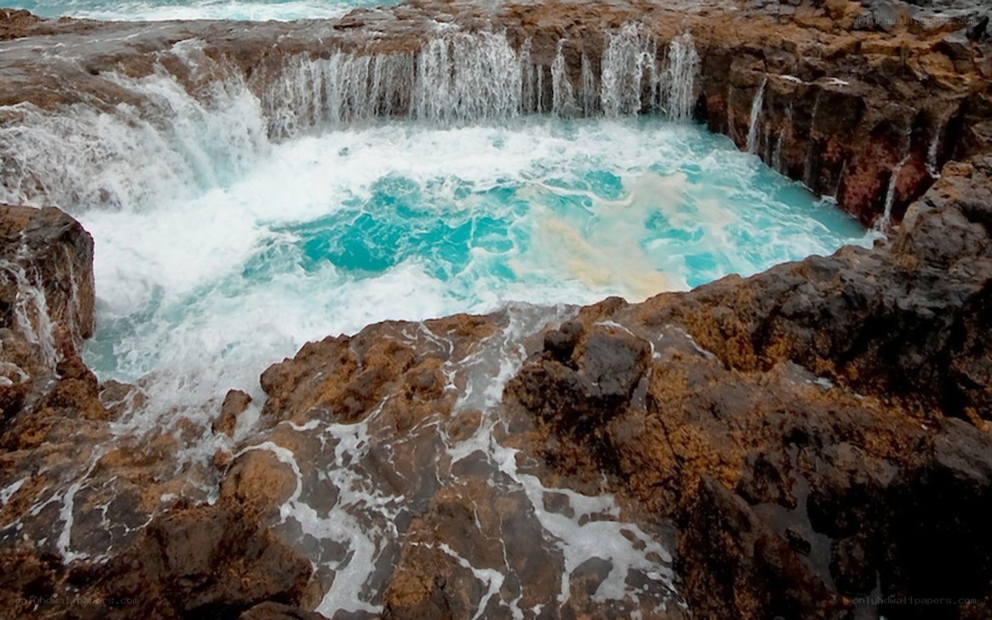 ocean waterfall on rocky coast