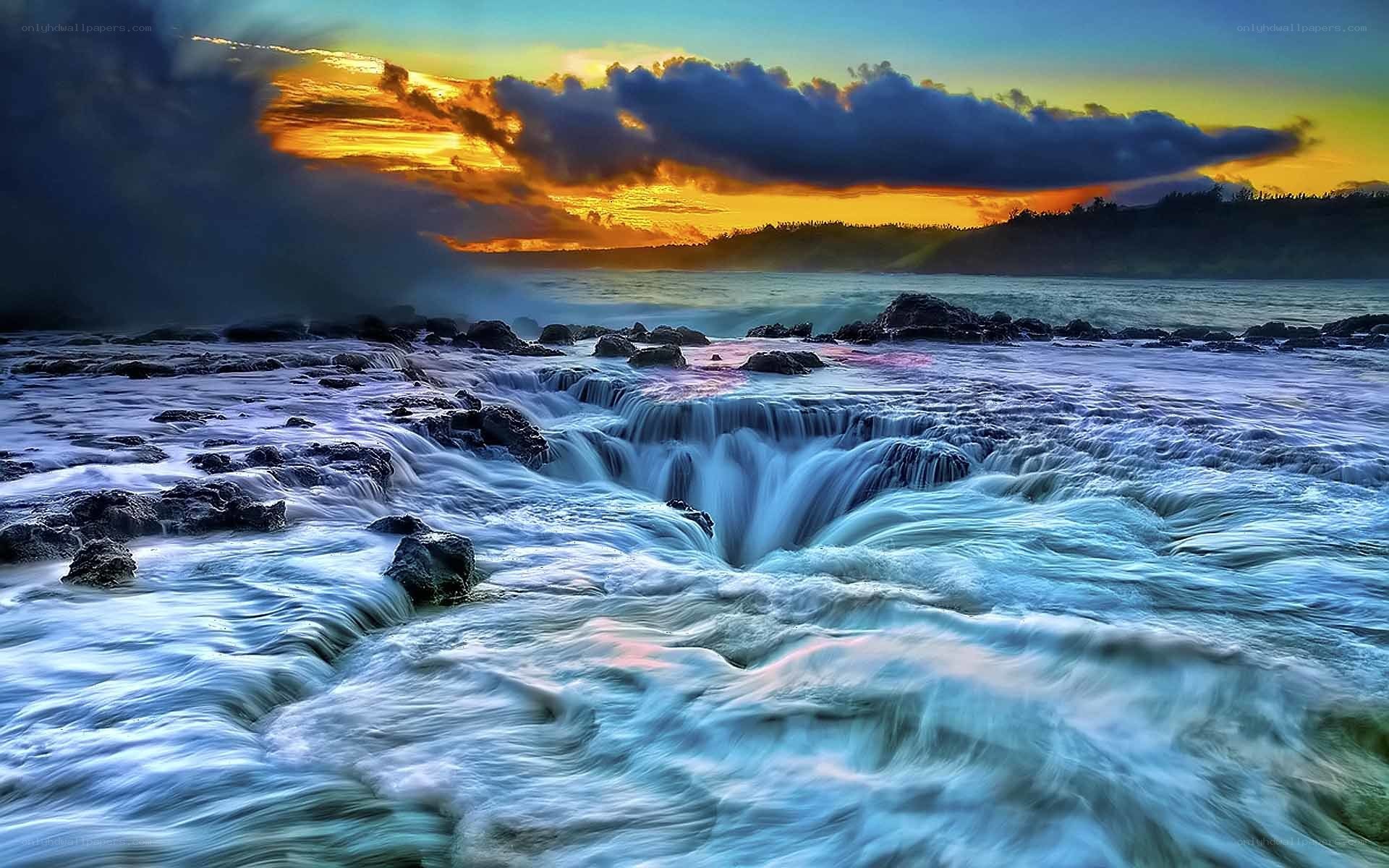 Ocean waterfalls at sunset