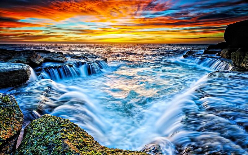 Ocean waterfalls at sunset