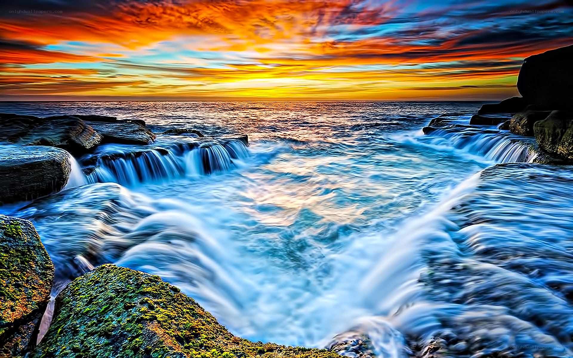 Ocean waterfalls at sunset