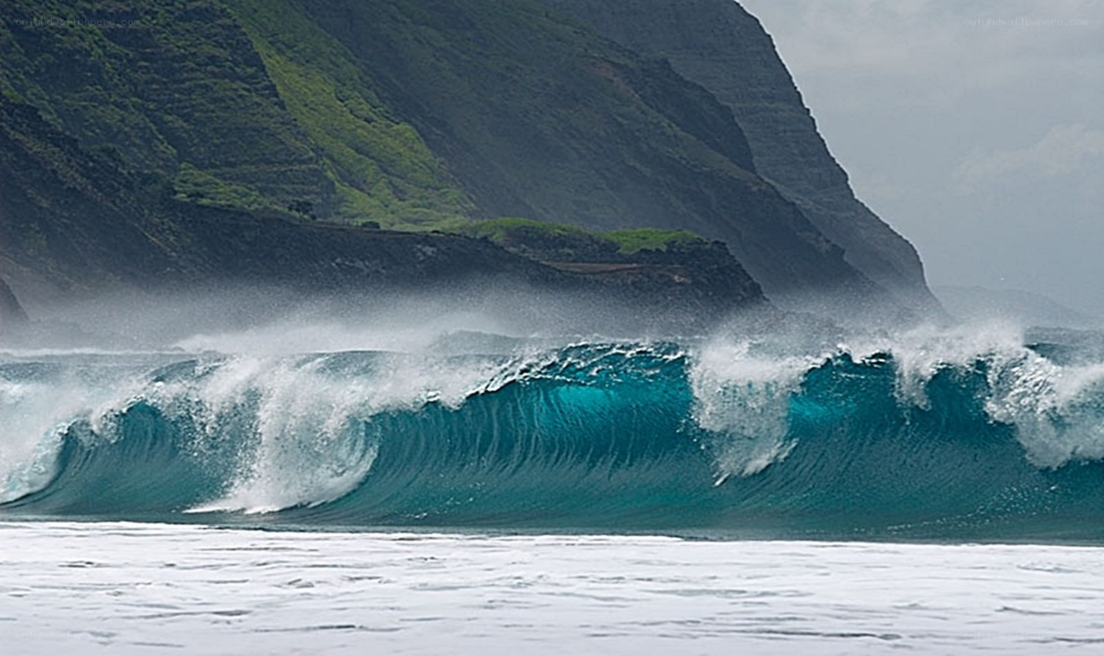 Ocean wave crashing against cliffs