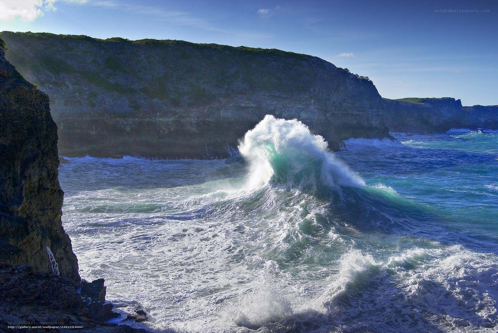 Ocean wave crashing against cliffs