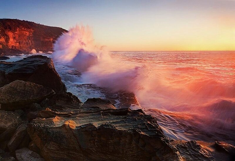 Ocean wave crashing at sunset
