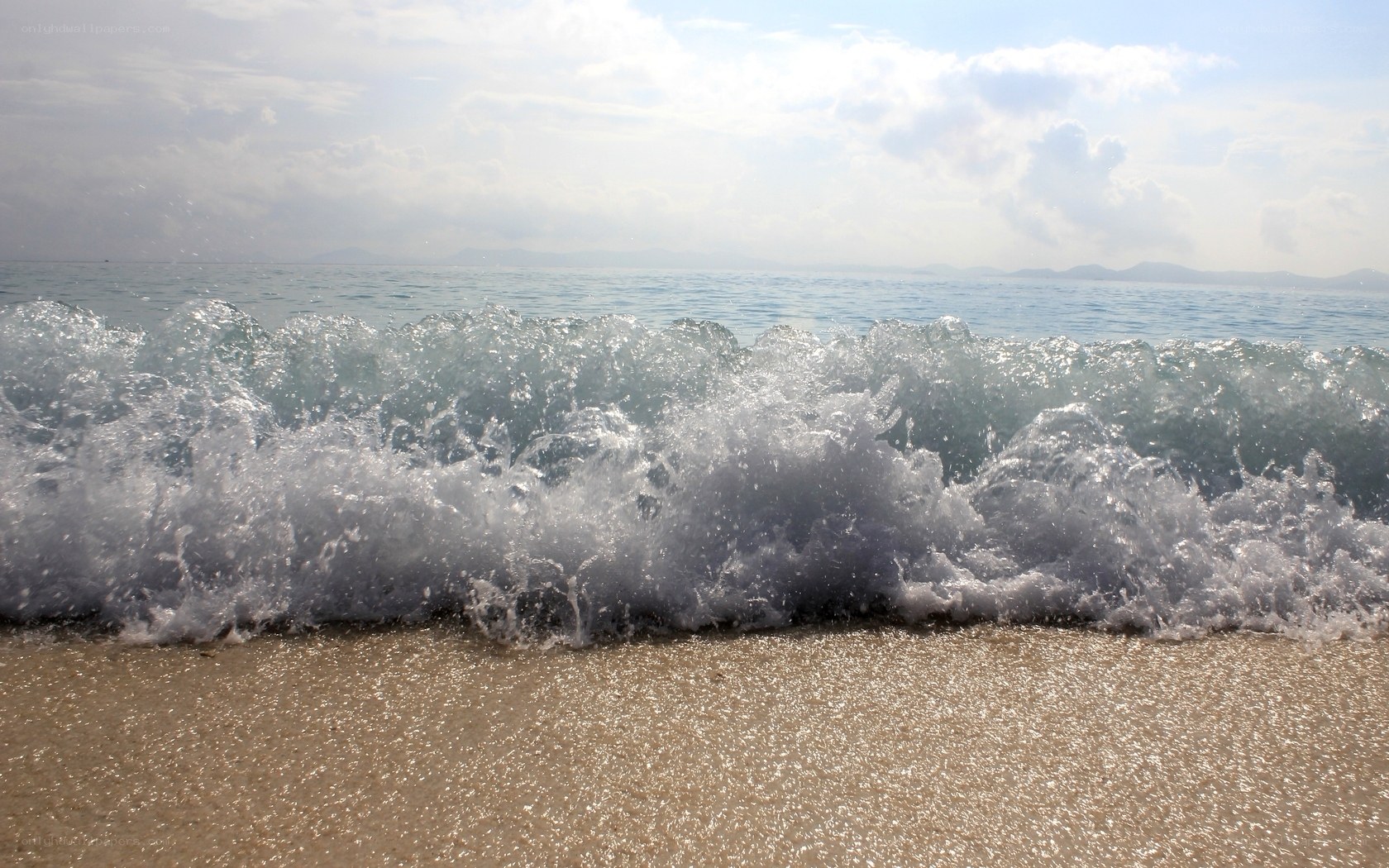 Ocean wave crashing on beach