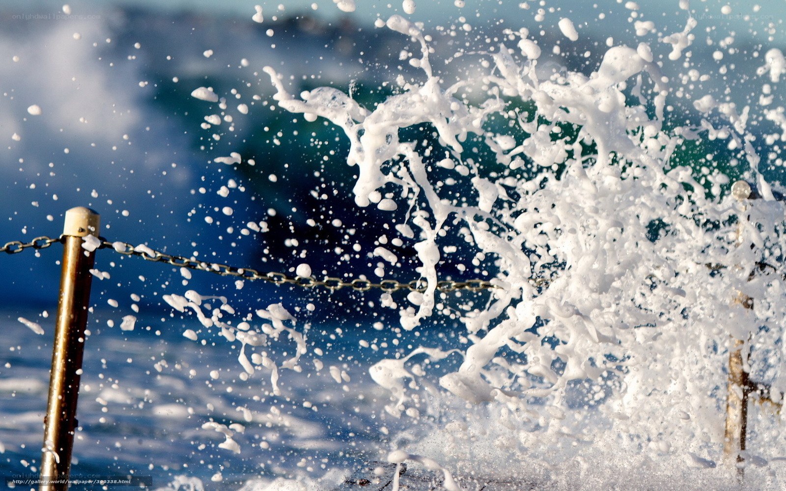 Ocean wave crashing on chain barrier