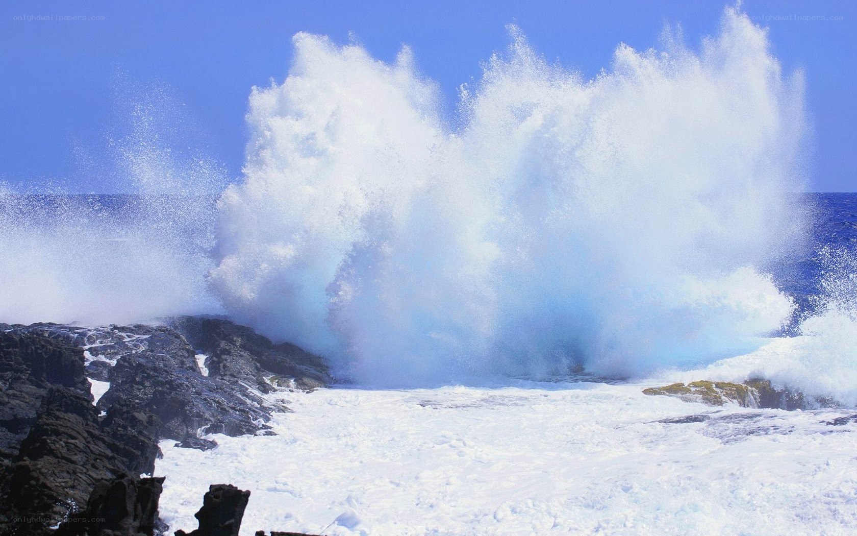 Ocean wave crashing on rocks