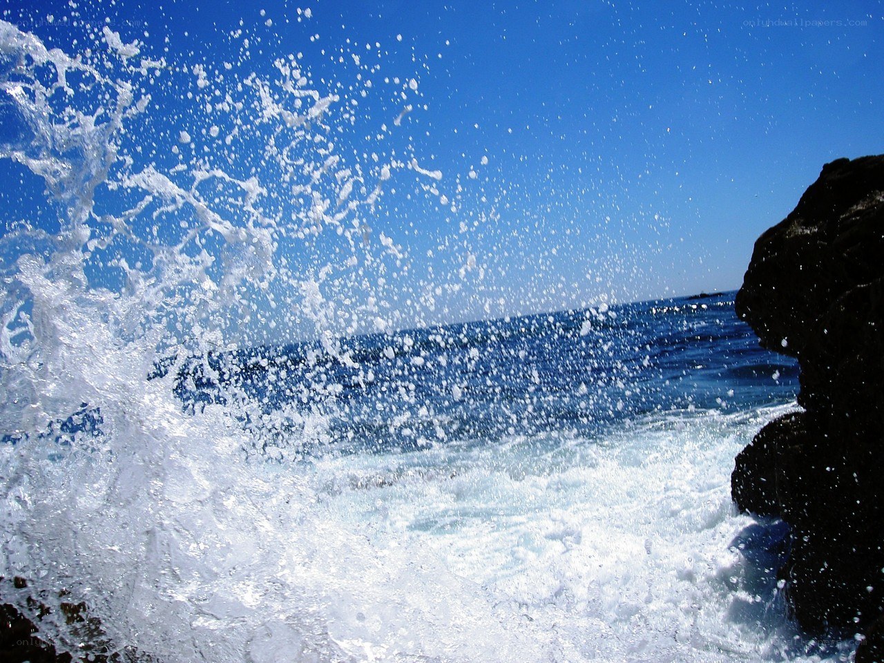Ocean wave crashing on rocks