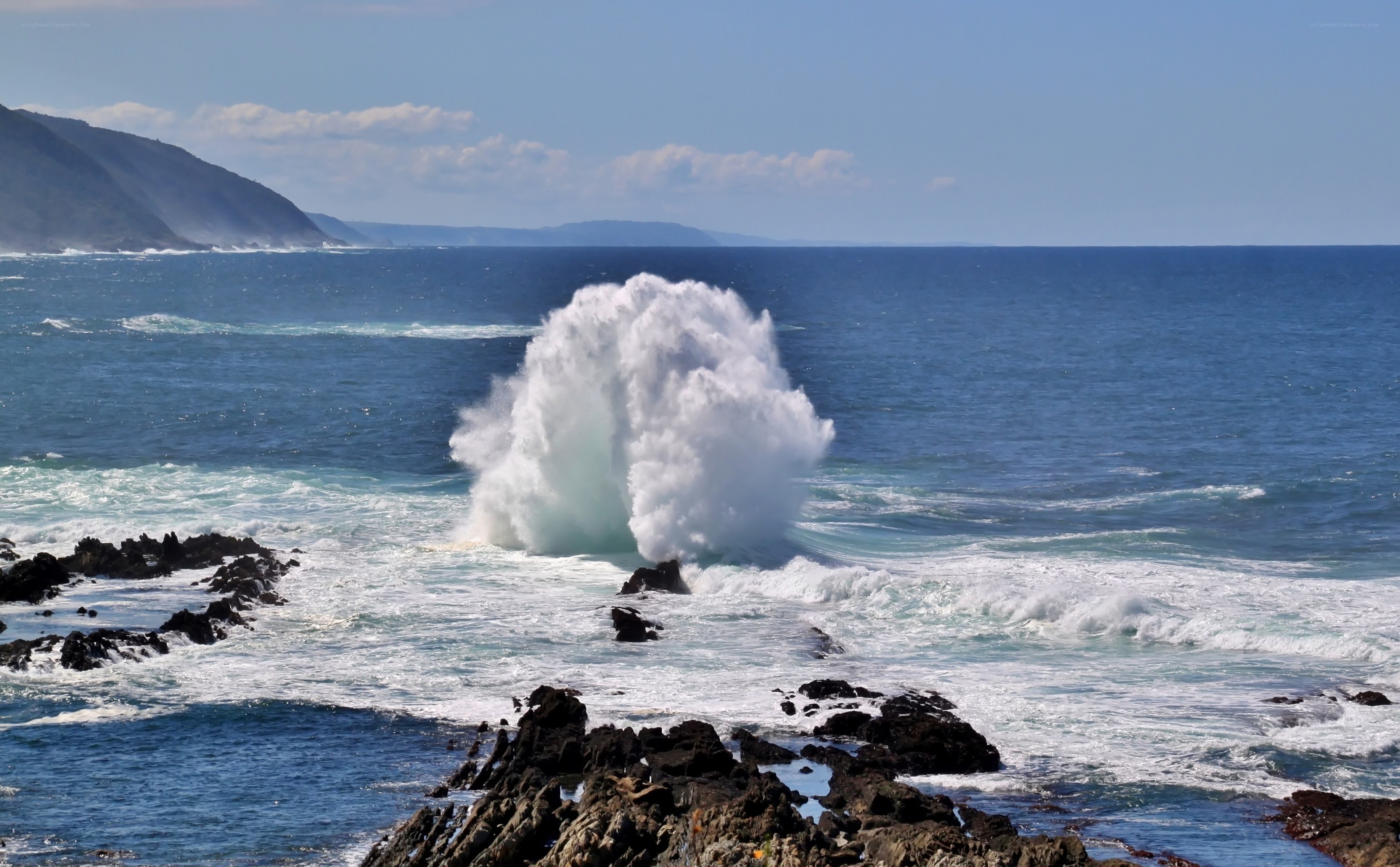 Ocean wave crashing on rocks