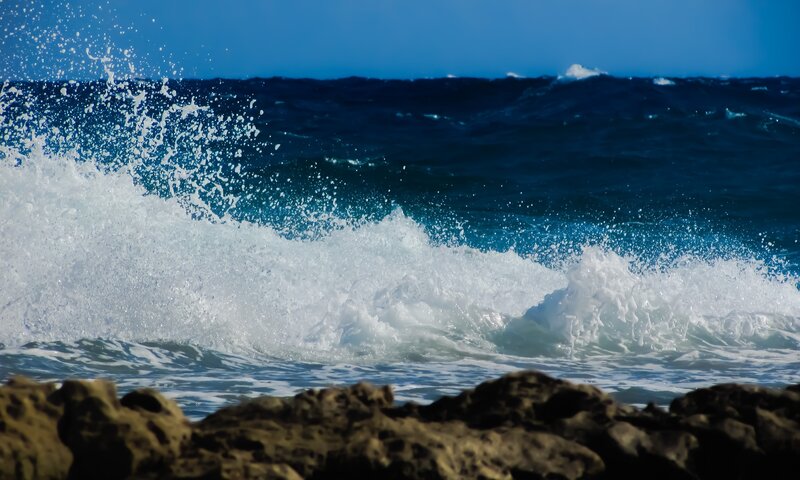 Ocean wave crashing on rocks