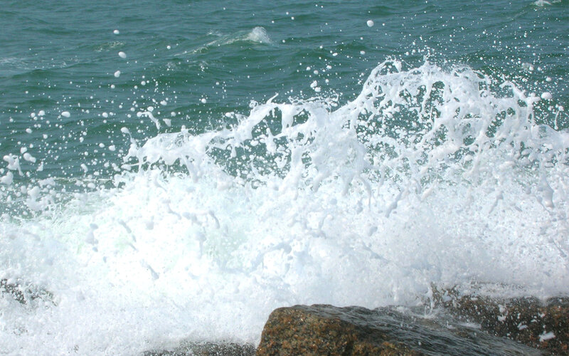 Ocean wave crashing on rocks