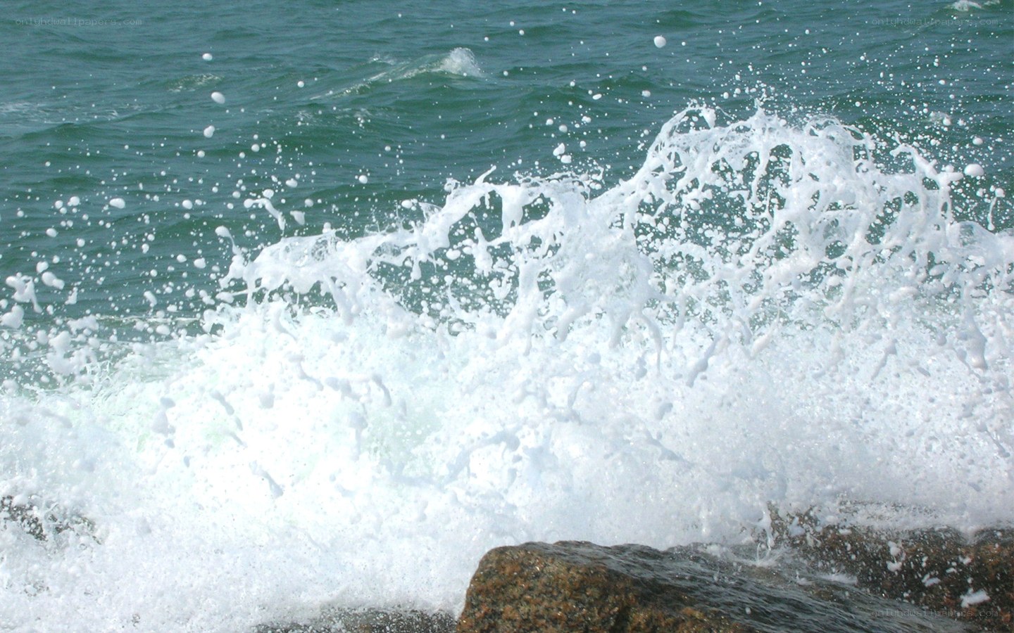 Ocean wave crashing on rocks