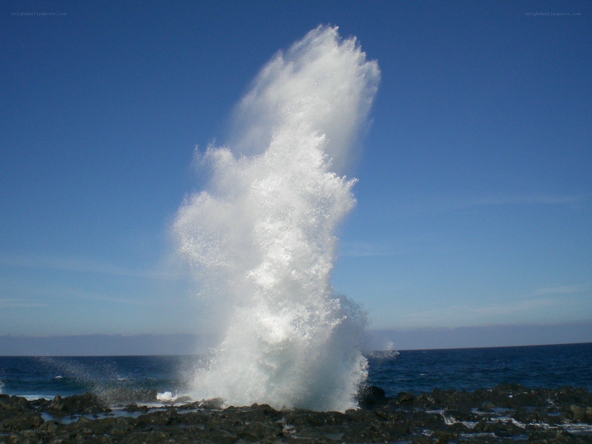 Ocean wave erupting from rock