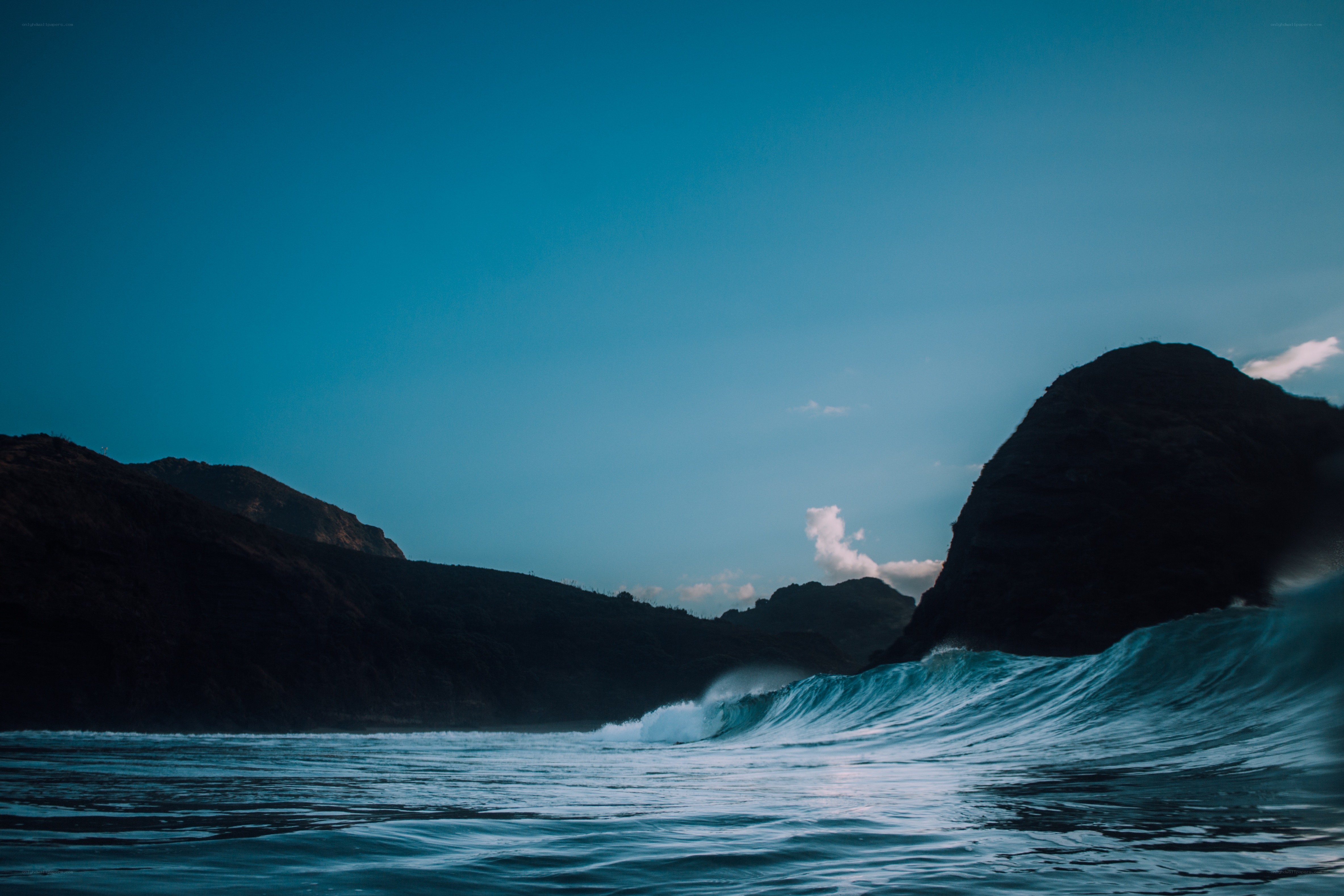 Ocean wave near rocky cliffs