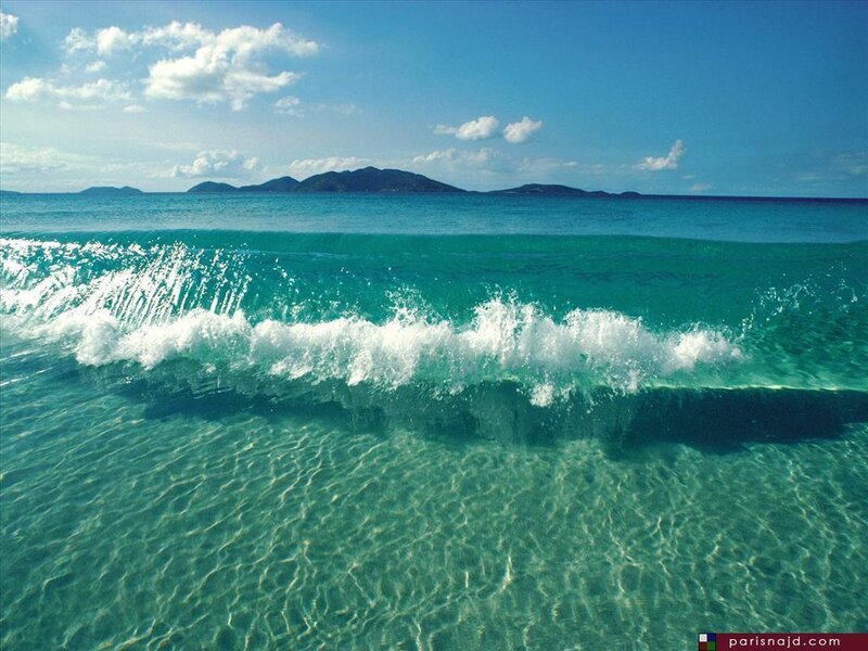 Ocean wave with distant islands
