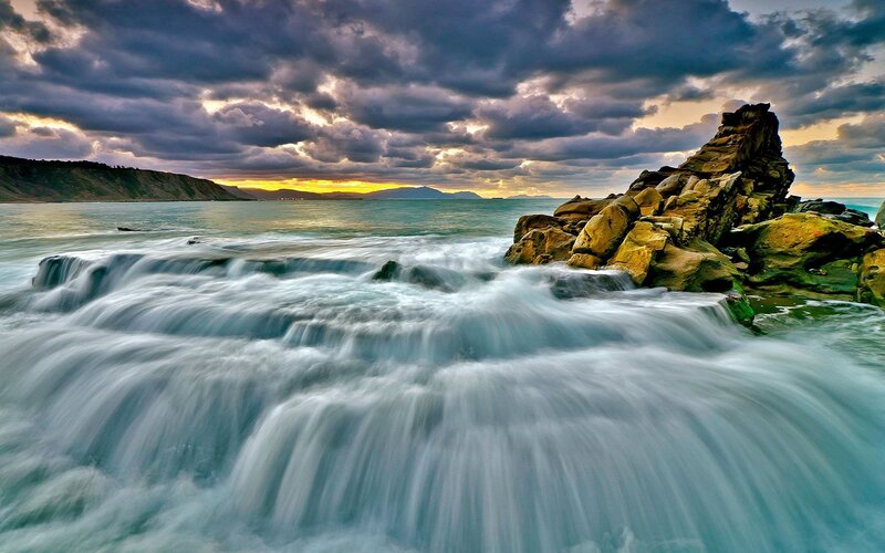 Ocean Waves at Rocky Shore — Blue, Dramatic, Sunset, Photograph, Rocks, Clouds