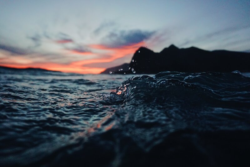 Ocean Waves at Sunset — Blue, Dramatic, Photograph, Mountain, Sky