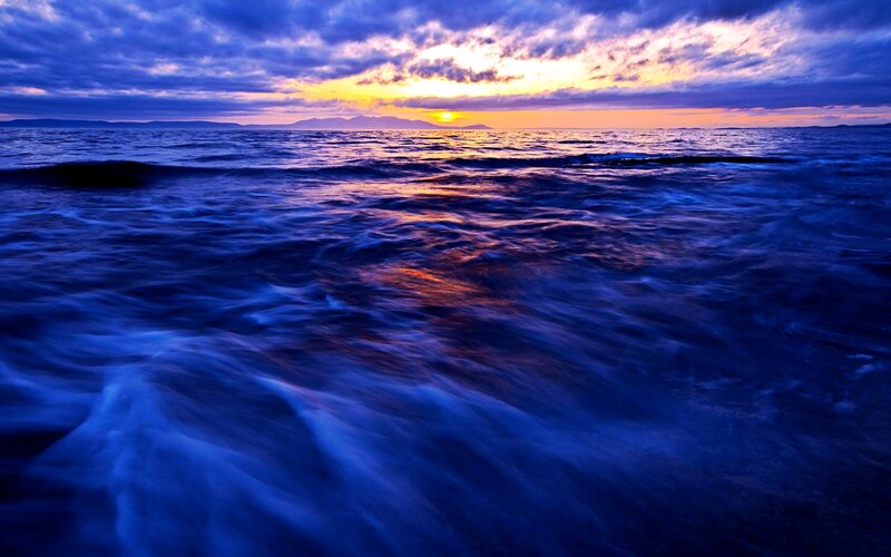 Ocean Waves at Sunset — Blue, Dramatic, Photograph, Sun, Clouds, Mountains