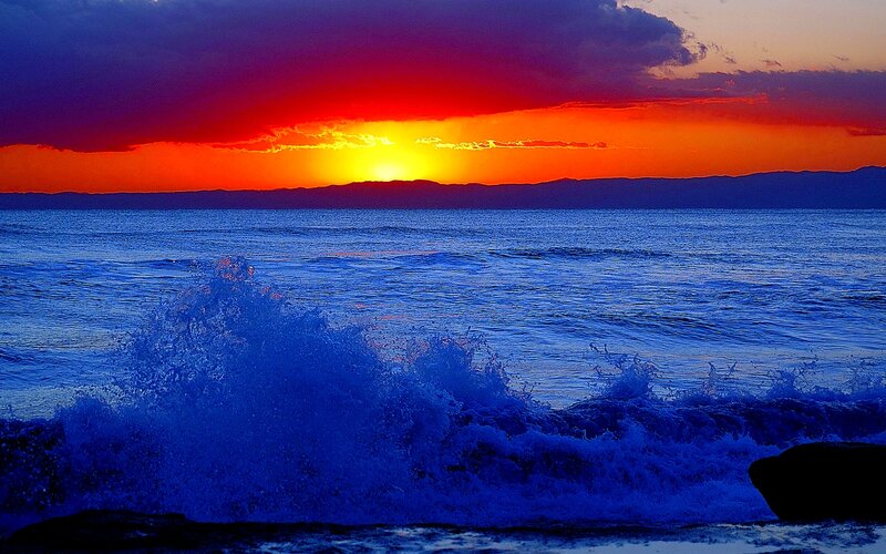 Ocean Waves at Sunset — Blue, Dramatic, Photograph, Sun, Sky, Mountains