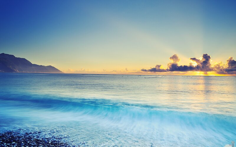 Ocean Waves at Sunset — Blue, Serene, Photograph, Mountain, Clouds, Pebbles