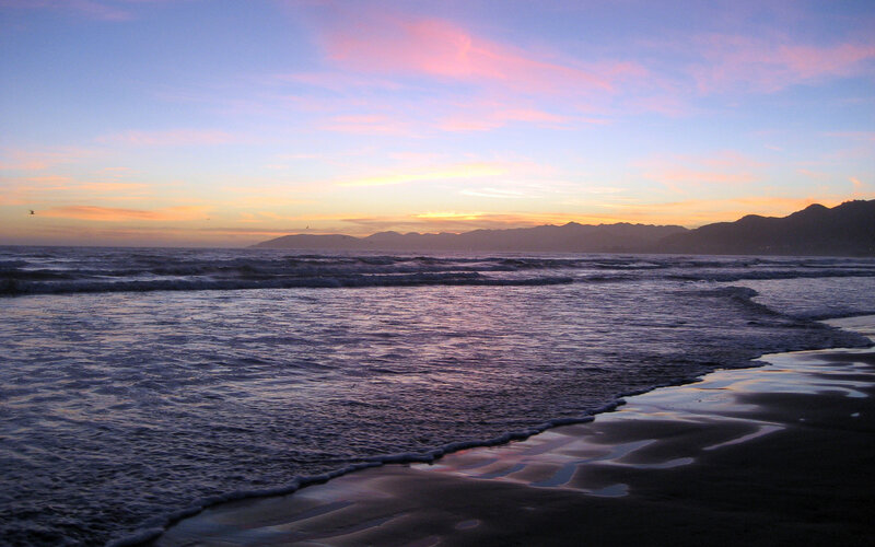 Ocean Waves at Sunset — Blue, Serene, Photograph, Mountains, Sky, Beach, Pink, Orange