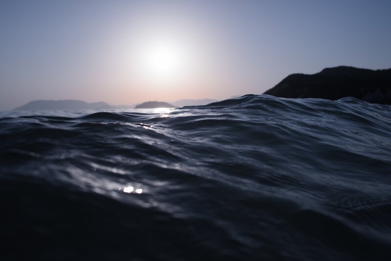Ocean Waves at Sunset — Blue, Serene, Photograph, Sun, Mountains, Sea