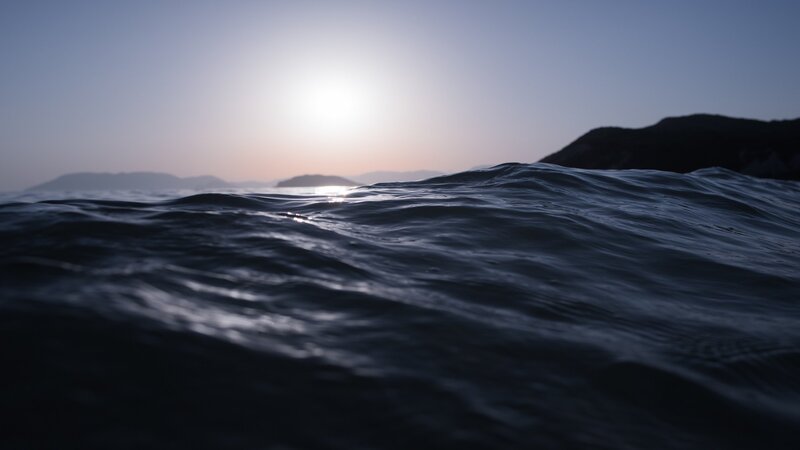 Ocean Waves at Sunset — Blue, Serene, Photograph, Sun, Mountains