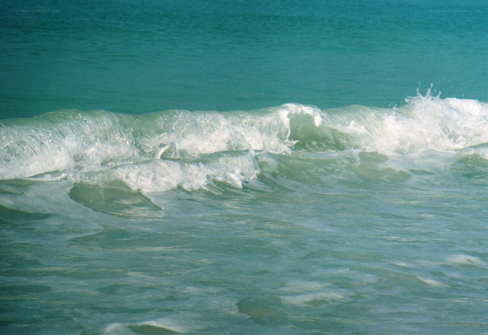 Ocean waves breaking on shore