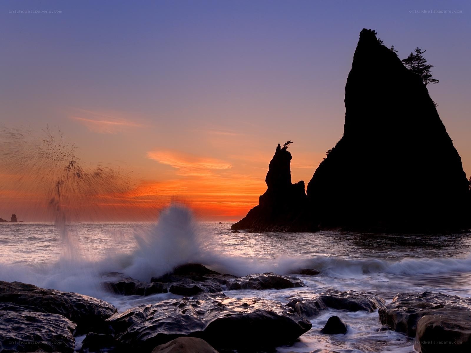 Ocean waves crash at sunset