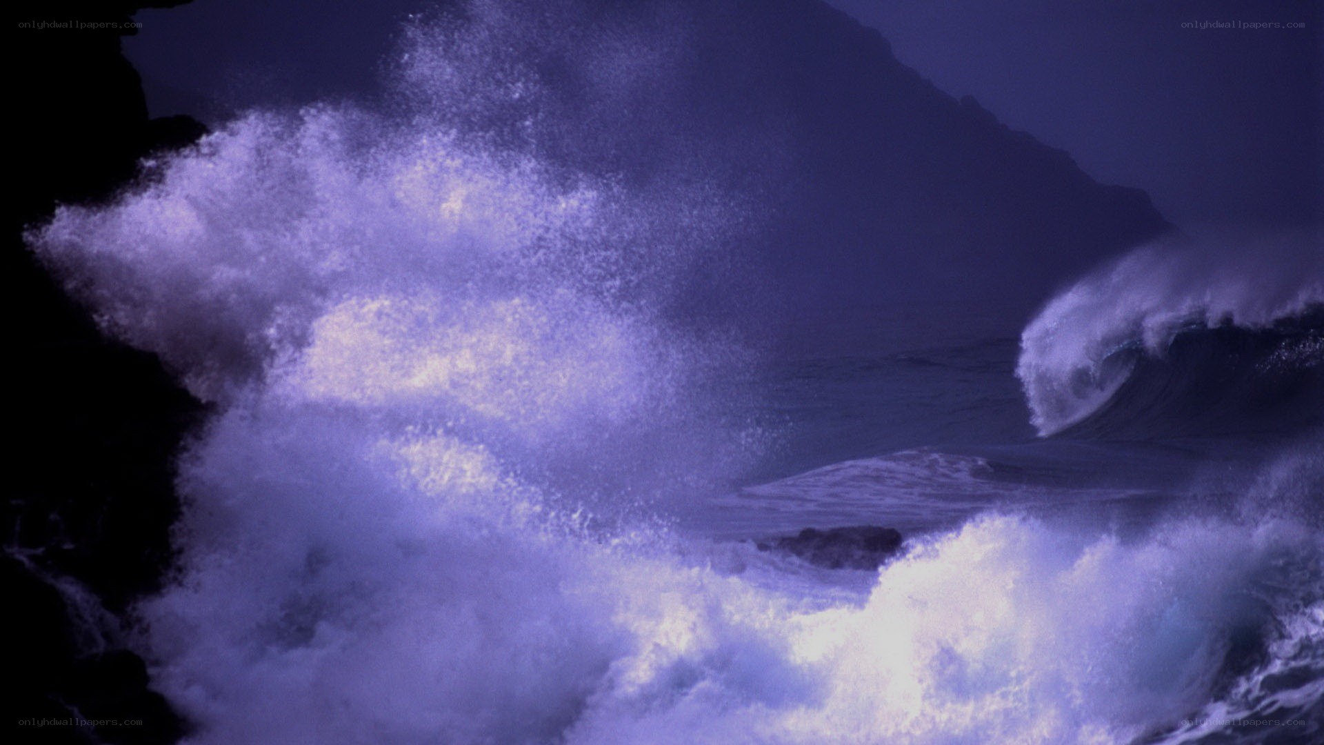 Ocean waves crashing at night