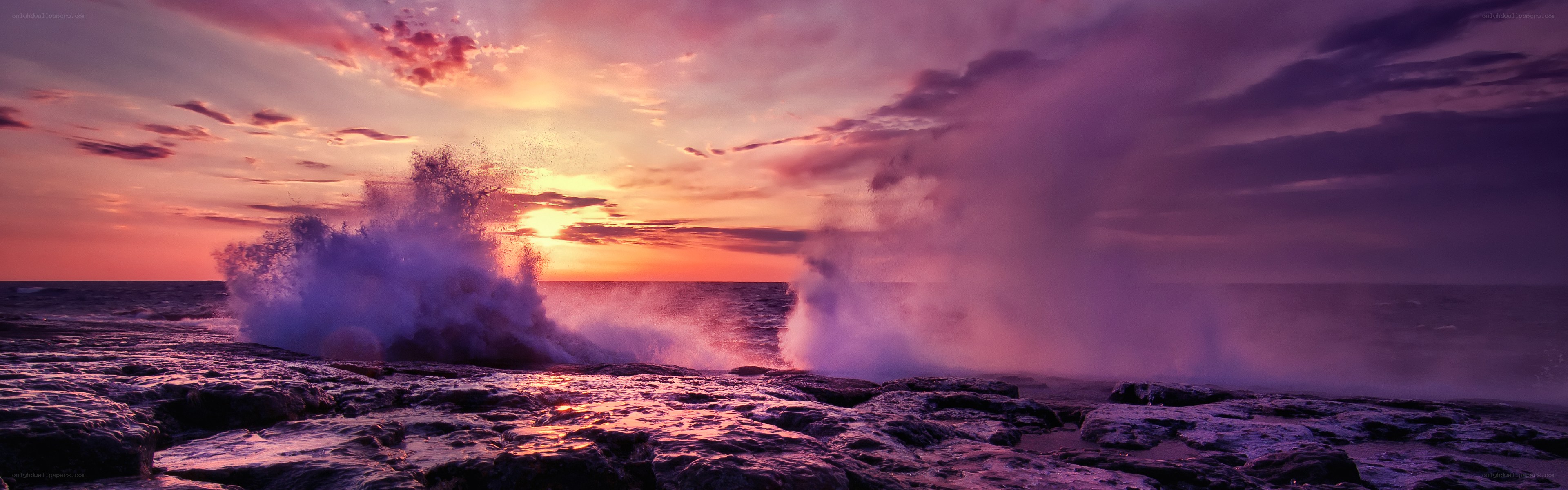 Ocean waves crashing at sunset