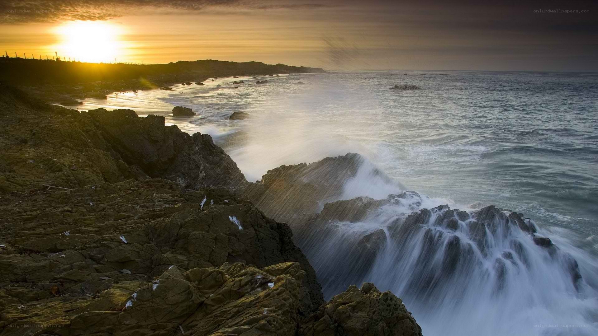 Ocean waves crashing at sunset