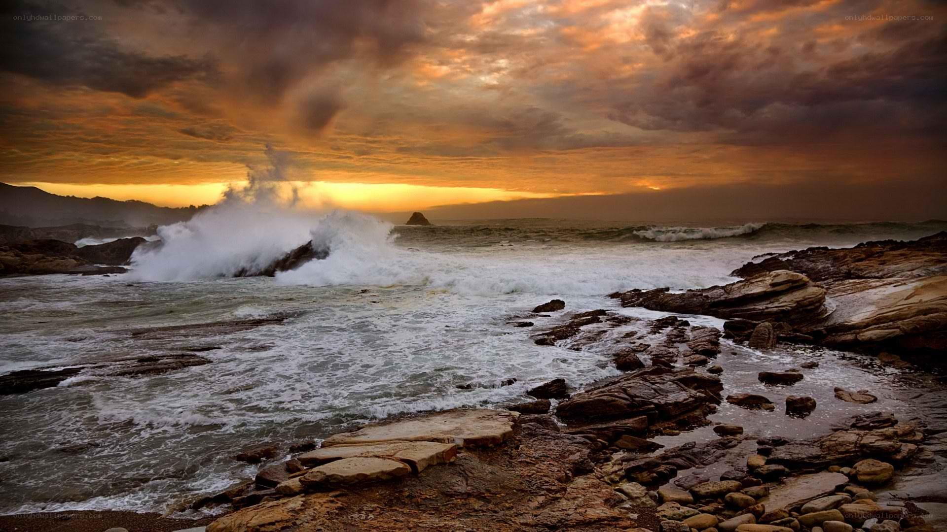 Ocean waves crashing at sunset